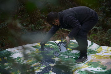 Wang Jun blind painting in Guizhou forest - © Courtesy of the artist and A Thousand Plateaus Art Space, Paris Internationale