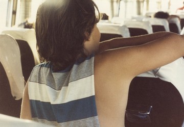 George Tourkovasilis, Untitled [Boy in striped shirt from boys in transit series], C-print on Kodak paper, c.1985, 8.8 x 12.3 cm - © Courtesy The George Tourkovasilis Archive and Records, Athens, Paris Internationale