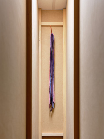 Georges J. Ayrault, **For (Pour)**, 2025
Installation, unique piece (30 x 200 x 250 cm)
Three ties (including two offered by Audrey, friend of Georges), held by a
knitting needle, hidden in a wall built of MDF and wood, painted in purple
(with paint coming from a paint shop in Villeperdue which closed and
whose remaining stock was bought by a materials resale shop).
Photo ©Nicolas Lafon - © Photo &copy;Nicolas Lafon, Paris Internationale