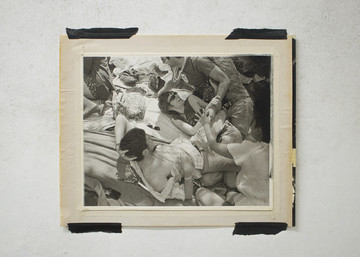 Juliana Halpert is always asking what a photo holds—what is contained not simply within a particular image, but within the larger set of actions that constitute photography as a site of cultural production. For Halpert, a photograph is always evidence—not in the usual sense of documenting a specific place or event or thing—but rather of itself; of the acted-upon desire to record something through the network of social and technologic mechanisms we refer to as “photography.” Because of this, Halpert’s work is not solely occupied with the visual—she seems as much concerned with what is captured by the act of taking a photograph, and the circumstances informing that act, as with what is depicted in it. 

Founder’s day, 2011/2023. Gelatin silver print on matboard. From the series “Dominus Tuus” - © (link: https://julianahalpert.com/ text: Juliana Halpert), Paris Internationale